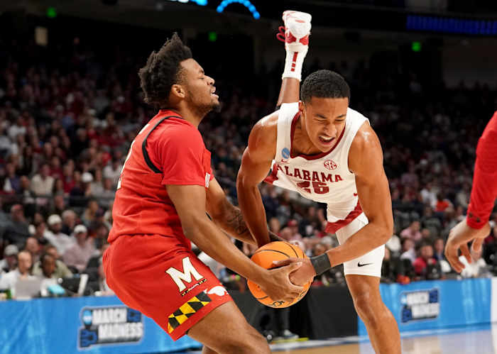 Mar 18, 2023; Birmingham, AL, USA; Maryland Terrapins guard Jahari Long (2) and Alabama Crimson Tide guard Nimari Burnett (25) tie up the ball during the first half at Legacy Arena.